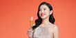 Beautiful asian girl in evening dress smiling, holding glass of champagne