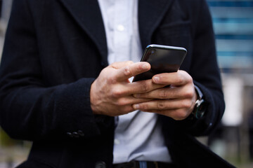Poster - Business man, phone and hands typing outdoor for communication, social media or chat. Closeup of male entrepreneur person with smartphone in city for network, internet connection or mobile travel app