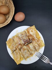 Wall Mural - Roti with banana and egg on black background