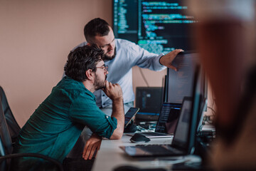 programmers engrossed in deep collaboration, diligently working together to solve complex problems a