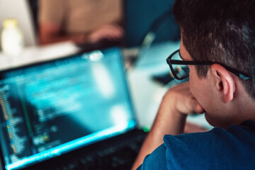 A programmer diligently testing smartphone applications while sitting in their office.
