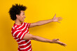 © deagreez - Photo of charming excited man dressed red t-shirt ready hug embrace empty space isolated yellow color background