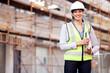 © Shadroy J/peopleimages.com - Portrait, engineer and woman with construction, business and smile with inspection, vest and helmet. Face, female person or employee with safety, documents and builder with a hard hat or architecture