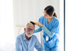 © NVB Stocker - comb hair for old people. Asian female caregiver helping senior caucasian male dress up at home care. Professional caregiver nursing home