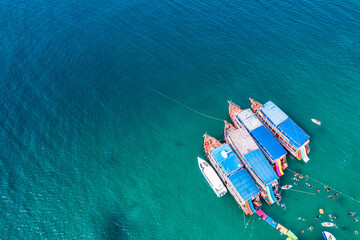 Wall Mural - Traditional ferry anchored and tourist snorkeling and enjoying with coral reef in tropical sea