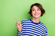 Photo of cute woman showing mockup empty space look interested wondered wear pullover isolated green color background
