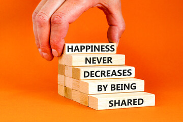 Wall Mural - Happiness symbol. Concept words Happiness never decreases by being shared on wooden block. Businessman hand. Beautiful orange table orange background Motivational Happiness concept. Copy space.
