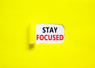 Stay focused symbol. Concept words Stay focused on beautiful white paper on a beautiful yellow background. Business, support, motivation, psychological and stay focused concept. Copy space.