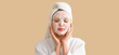 © Pixel-Shot - Young woman with applied sheet facial mask on beige background