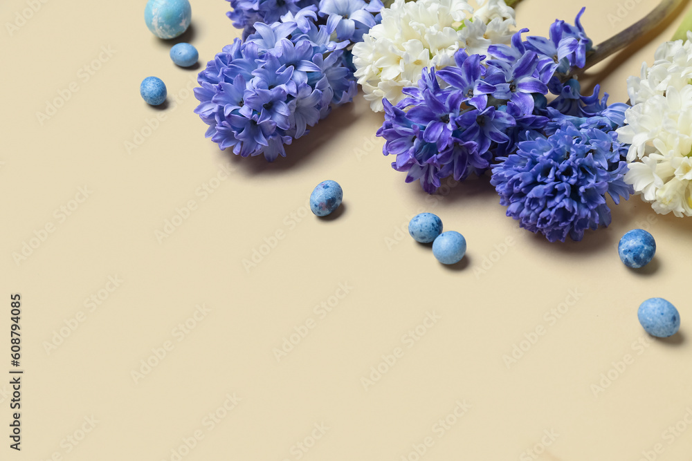 Beautiful hyacinth flowers and Easter eggs on beige background