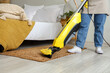© Pixel-Shot - Housewife hoovering carpet in bedroom