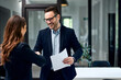 © bnenin - A smiling male employer handshake with a businesswoman before the meeting.