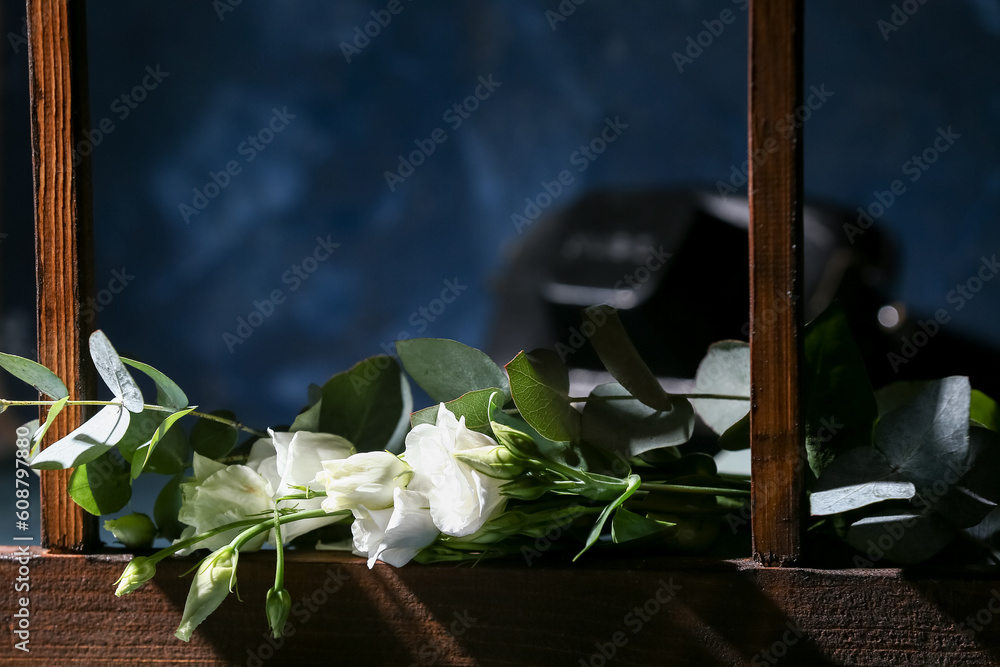 Bouquet of beautiful eustoma flowers on windowsill