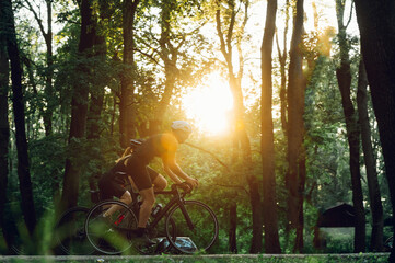 Wall Mural - Couple riding bicycles outside of the city and wearing helmets and sunglasses