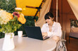 © Ananass - Happy girl relaxing on vacation. Camping young woman sitting in camp tent. Young female caucasian model reading text and work on notebook