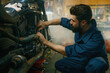 © Nomad_Soul - Young mechanic working on motorcycle in garage repair service