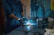 © Nomad_Soul - Repairman wearing protective helmet working with welding at motorcycle workshop