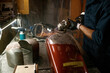 © Nomad_Soul - Repairman grinding motorcycle body part from old paint using stripping machine
