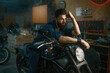 © Nomad_Soul - Portrait of brutal man mechanic sitting on repaired motorcycle