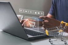 Young Man Hands Holding Credit Card And Using Laptop With Shopping Cart Icon. Online Shopping, Online Payment And E-commerce Concept. Business Financial Technology. Hand Typing On Keyboard.
