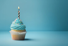 Birthday Cupcake With A Candle On A Light Blue Background, Generative AI