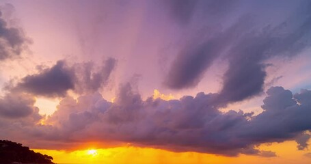 Wall Mural - Dramatic colorful clouds background,Beautiful 4K Time lapse of Majestic sunset clouds sky landscape,Amazing light of nature cloudscape sunset or sunrise sky and Clouds moving away rolling over sea