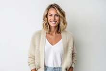 Lifestyle portrait photography of a satisfied woman in her 30s that is wearing a chic cardigan against a white background . Generative AI