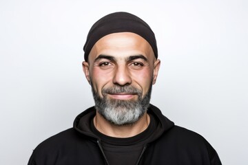 Portrait of a bearded man in a black hoodie on a white background