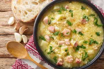 Poster - Cossack Ukrainian rich soup kulish made of millet, potatoes, onions with bacon close-up in a plate on the table. horizontal top view from above