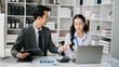 © laddawan - Asian business colleague business presents and explains and using laptop and tablet. Teamwork, financial marketing team, while sitting in office room.