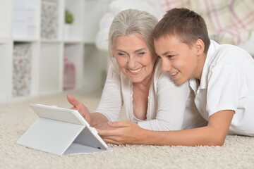 girl with grandmother using tablet