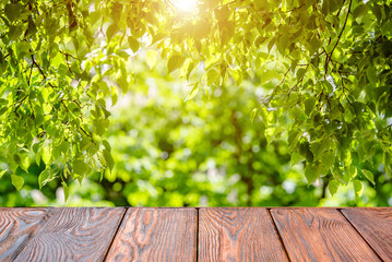 Wooden table and blurred green natural background