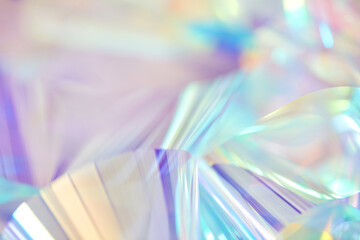Fototapete - Blurred close-up of ethereal pastel neon blue, purple, lavender, yellow holographic metallic foil background. Abstract modern curved surreal futuristic disco, rave, techno, festive dreamlike backdrop