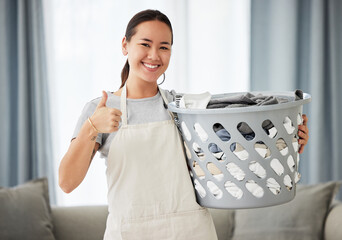 Poster - Happy asian woman, laundry and thumbs up for housekeeping, cleaning or hygiene at home. Portrait of female person, cleaner or domestic with smile and thumb emoji, yes sign or like for clean clothing