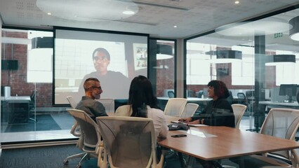 Wall Mural - Group of diverse professionals having an online meeting in a boardroom. Business team discussing a new partnership opportunity with remote associates as they connect over a video conference.