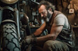 © Michael Schauer - portrait of a male mechanic repairing a motorcycle