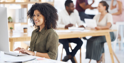 Computer, workspace and happy woman, web designer or creative employee typing online, internet or research. Worker, happy and african person on desktop pc in workplace, business or office webdesign