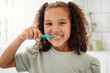 © K.A./peopleimages.com - Toothbrush, brushing teeth and portrait of a child in a home bathroom for dental health and wellness with smile. Face of Latino girl kid learning to clean her mouth for morning routine and oral care