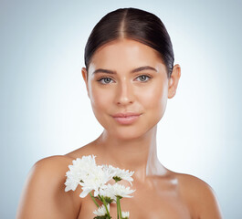 Wall Mural - Skincare, face and woman with daisy flower in studio isolated on a white background. Portrait, natural plant and female model with spring floral for makeup cosmetics, beauty treatment and wellness.