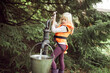 © Flamingo Images - Little girl filling a bucket with water outside during vacation