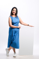 Wall Mural - Indian woman showing empty board on white background.