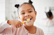 © K.A./peopleimages.com - Toothbrush, brushing teeth and face of a child in a home bathroom for dental health and wellness. Smile portrait of african girl kid cleaning mouth with a brush for morning routine and oral self care