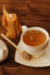 Wall Mural - Herbal green tea in a white cup on the table.