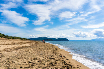 Wall Mural - Large and sandy beach in the Rimigliano Park, protected area in the municipality of San Vincenzo, Tuscany region, Italy, with two people in the distance walking