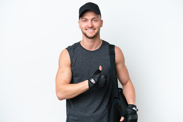 Wall Mural - Young blonde sport caucasian man with sport bag over isolated white background giving a thumbs up gesture