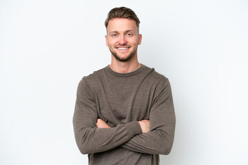 Wall Mural - Young blonde caucasian man isolated on white background keeping the arms crossed in frontal position