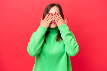 Wall Mural - Middle-aged caucasian woman isolated on red background covering eyes by hands