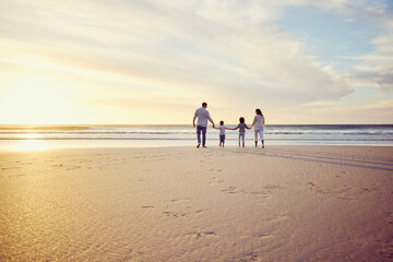 Canvas Print - Sunset, travel and family holding hands on beach walking on holiday, summer vacation and weekend. Nature, mockup and mother, father and children by ocean for bonding, adventure and quality time