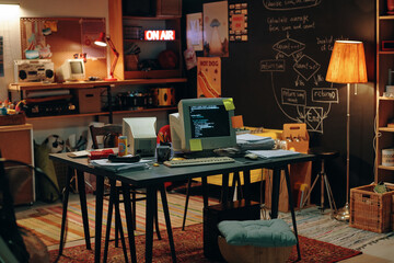 horizontal image of old-fashioned garage with computers for work