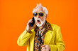 Cool senior man with fashionable outfit portrait - Old and funny grandfather wearing stylish and colorful clothing portrait on colored background